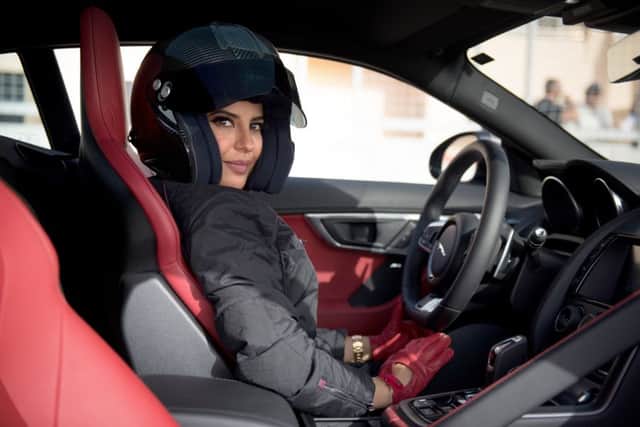Racing driver Aseel Al Hamad drives for the first time in her home country; Fadya Fahad, gives the thumbs-up, right; women celebrate driving on a main street. Picture: Fayiz Melibary/Getty Images for Jaguar