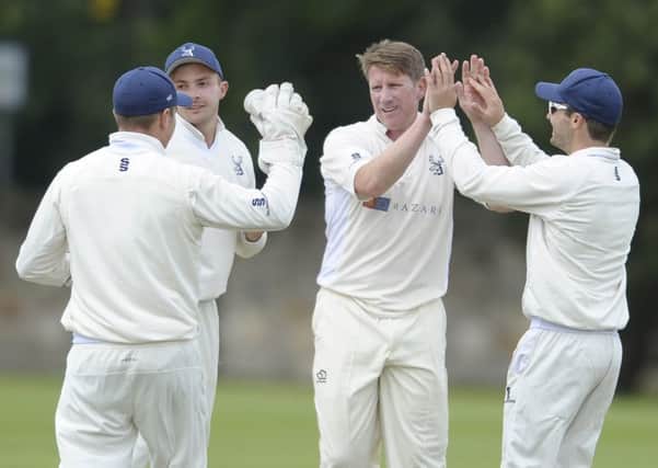 John Blain (third from right) celebrates the wicket of Michael Miler with his Grange team-mates. Pic: Neil Hanna