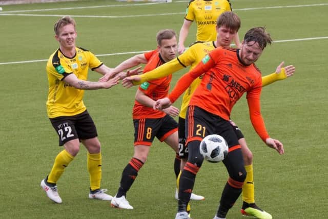 Hibs had two members of their backroom staff at Skala (in orange) v NSI Runavik (in black and yellow) last Friday. The match finished 1-1. Pic: JUULs-foto