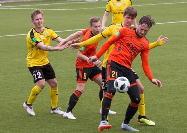 Hibs had two members of their backroom staff at Skala (in orange) v NSI Runavik (in black and yellow) last Friday. The match finished 1-1. Pic: JUULs-foto
