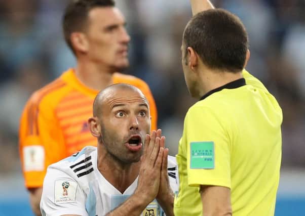 Argentina' Javier Mascherano pleads for mercy from ref Cuneyt Cakir. Picture: Getty
