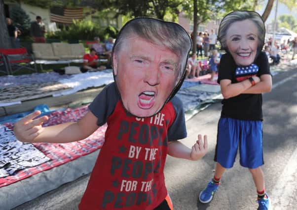 Two children wear Donald Trump and Hillary Clinton masks during the Provo Freedom Festival Parade on 4 July in Provo, Utah, one of the largest in the US to celebrate Independence Day. (Picture: Getty Images)