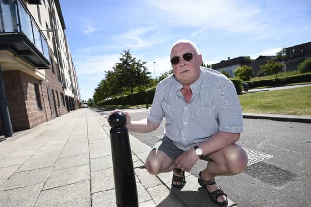 Andrew Wilson pictured with a bollard on Waterfront Avenue. Picture: Greg Macvean