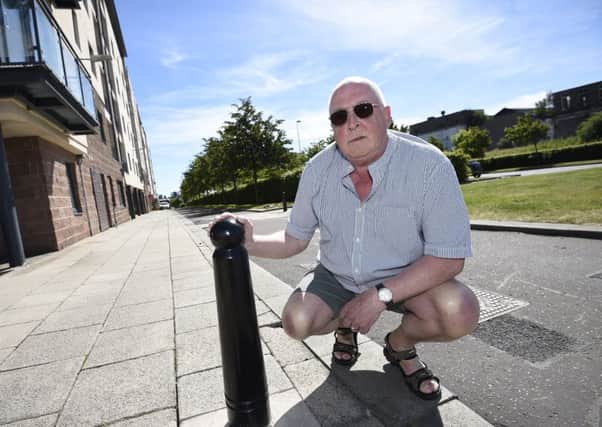 Andrew Wilson pictured with a bollard on Waterfront Avenue. Picture: Greg Macvean