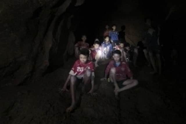 Photo released by Tham Luang Rescue Operation Center, shows the missing boys and their soccer coach as they were found in a dark, partially flooded cave, in Mae Sai, Chiang Rai, Thailand. Picture; AP