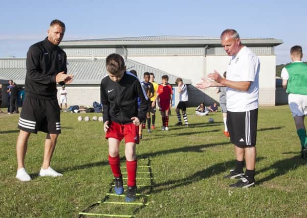 Josh Walker and Graham Buckley (white top) train kids at Drumbrae Leisure Centre. Pic: Alistair Linford