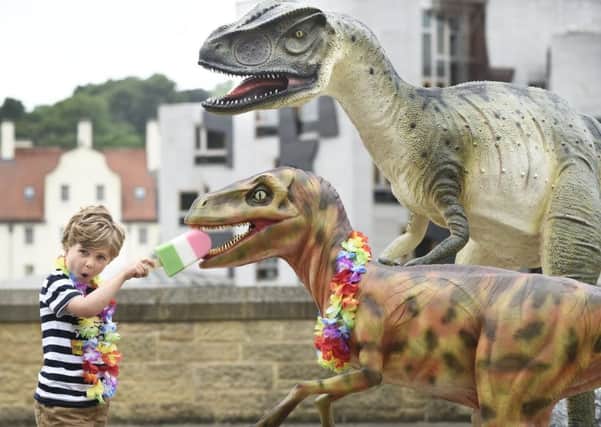 Fve-year-old Alexander McColville shares his ice lolly with a Dynamic Earth dinosaur. Picture: Lesley Martin