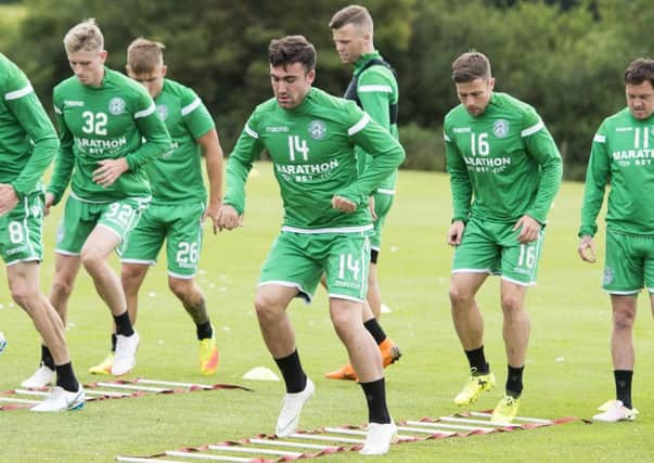 Stevie Mallan, centre, goes through his paces at training. Pic: SNS