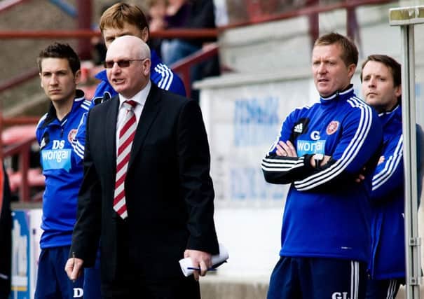John McGlynn looks on from the East End Park dugout with his coaching staff including Gary Locke, right