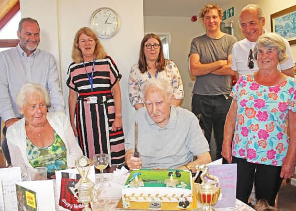 A bowling-themed birthday cake is presented to John by Viewpoint staff and neighbours