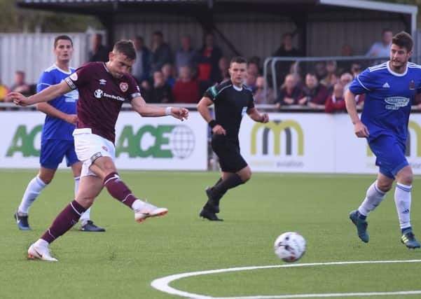 Olly Lee strikes home the opener for Hearts at Cove