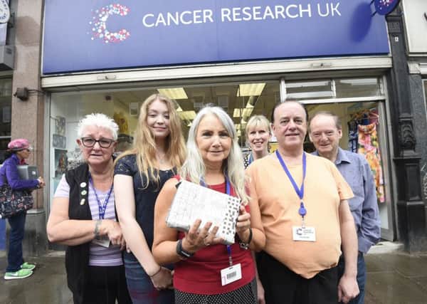 Margaret Armstrong, Alana Ferguson, Alison Hegarty (who took the newspaper parcel from the mystery man), Kate Dawes, Keith Gee, Colin Govier were shocked to receive the donation. Picture: Greg Macvean