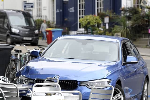 The blue BMW mounted the pavement outside the Cask and Barrel pub on Broughton Street. Picture: Neil Hanna