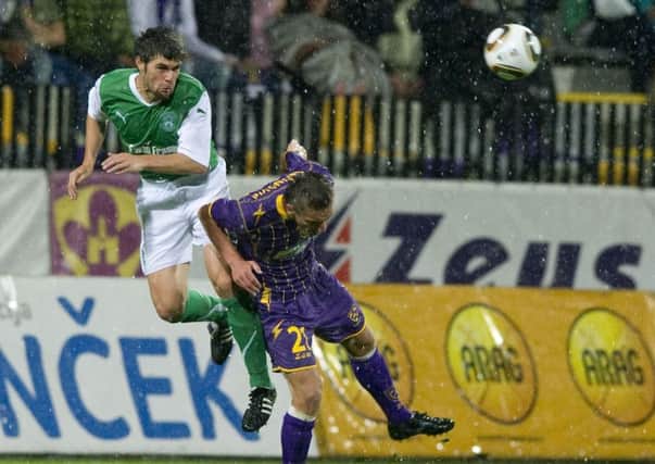 Hibs defender Michael Hart heads clear from Armin Bacinovic