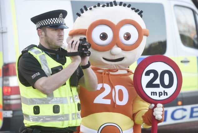 Edinburgh Council's 20mph mascot The Reducer is joined at Meadowbank by Hibs mascot Sunshine and Hearts mascot Jock to promote the extension of 20mph speed limits, with PC Ben Wray. Picture: Greg Macvean