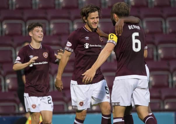 The imposing Peter Haring celebrates with Anthony McDonald and Christophe Berra after his first Hearts goal