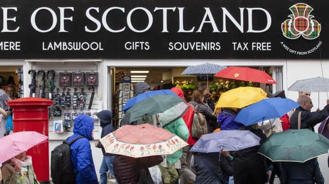 People in Edinburgh brave the rain as the weekend turns out to be a wash out across most of the UK. picture: Swns