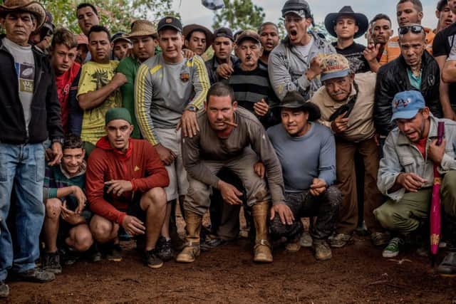 Men watching a cock fight in the countryside near Viñales, Picture: Tomas Munita/The New York Times