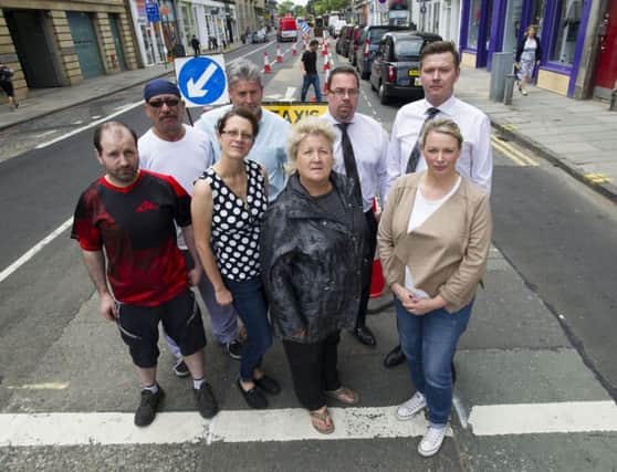 Kim McBride (second right front row ) pictured with shop keepers and owners of retail outlets in Haymarket Terrace. Picture: Ian Rutherford