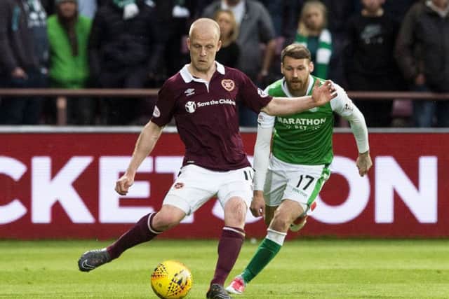 Hibernian's Martin Boyle competes with Hearts' Steven Naismith. Picture: SNS/Paul Devlin