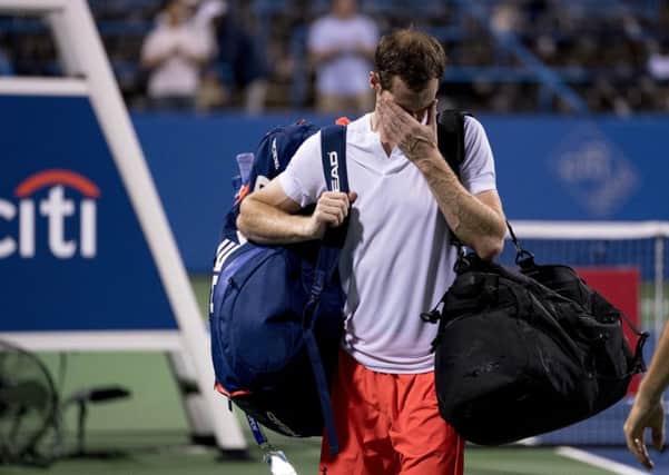 An emotional Andy Murray, of Britain, steps off the court after defeating Marius Copil, of Romania, 6-7(5), 3-6, 7-6(4), during the Citi Open tennis tournament in Washington, Friday, Aug. 3, 2018. (AP Photo/Andrew Harnik)