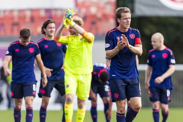 Hearts captain Christophe Berra and his team-mates applaud the fans at full-time. Picture: SNS