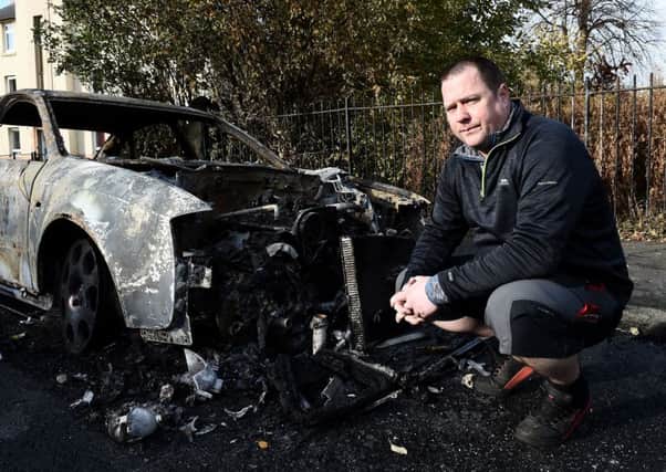 Alistair Clark - with his Audi that was set alight. Last year teenagers ran riot with  set cars on fire in a Bonfire Night of carnage in Pilton and Craigentinny