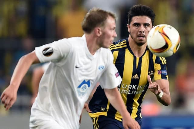 Fenerbahce's Ozan Tufan (R) vies for the ball with Molde's Eirik Hestad (L) during the Europa League football match between Fenerbahce and Molde on September 17, 2015 at the Ulker Fenerbahce Sukru saracoglu stadium in istanbul. AFP PHOTO / OZAN KOSE        (Photo credit should read OZAN KOSE/AFP/Getty Images)