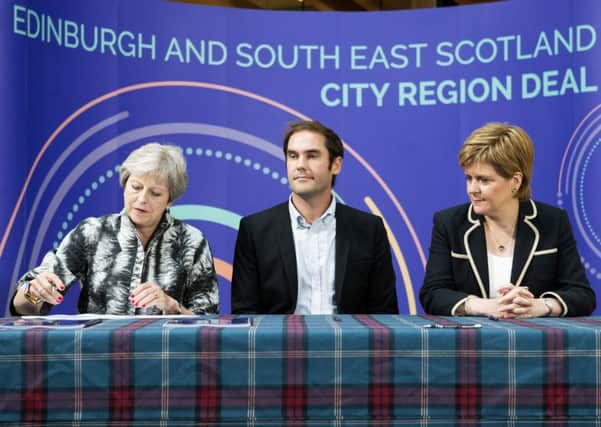 (L-R) Prime Minister Theresa May, City of Edinburgh Council leader Adam McVey and First Minister Nicola Sturgeon sign the Edinburgh and South East Scotland City Region Deal. Picture: Jane Barlow/PA Wire
