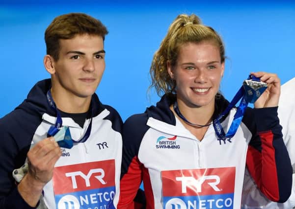 Grace Reid and Ross Haslam show off their silver medals just a few months after becoming a team. Pic: PA