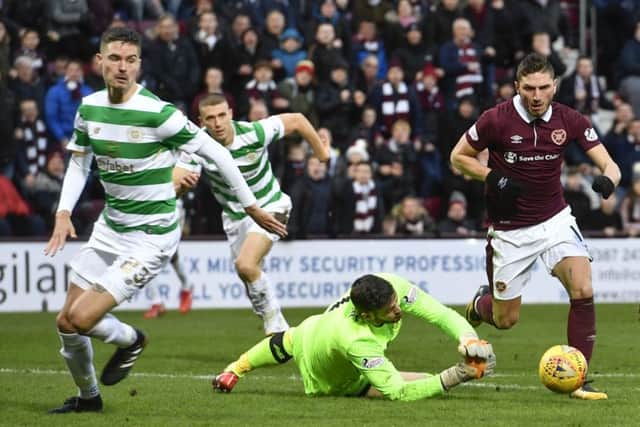 Hearts' David Milinkovic (right) rounds goalkeeper Craig Gordon before scoring his side's third goal during the 4-0 win over Celtic last season. Pic: SNS