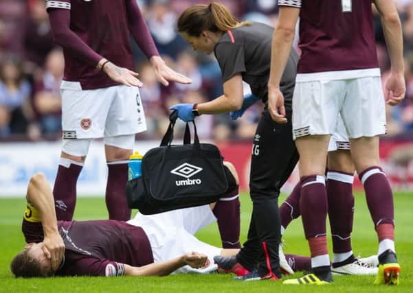 Hearts' Christophe Berra goes down injured. Pic: SNS/Ross Parker
