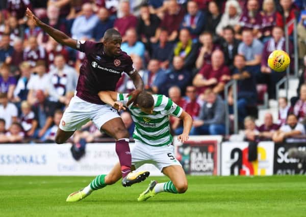 Uche Ikpeazu and Jozo Simunovic in action as the Hearts forward has an attempt on goal. Pic: SNS/Craig Williamson