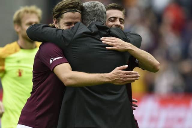 Craig Levein embraces Peter Haring and Olly Lee at full time