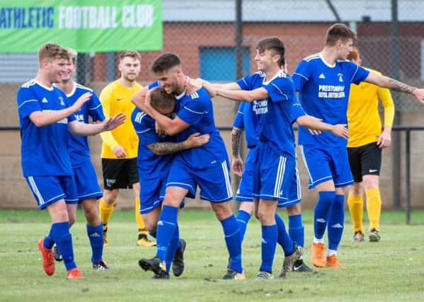 Lewis Turkington is mobbed by team-mates after scoring to put his side one-nil ahead. Picture: Ian Jacobs
