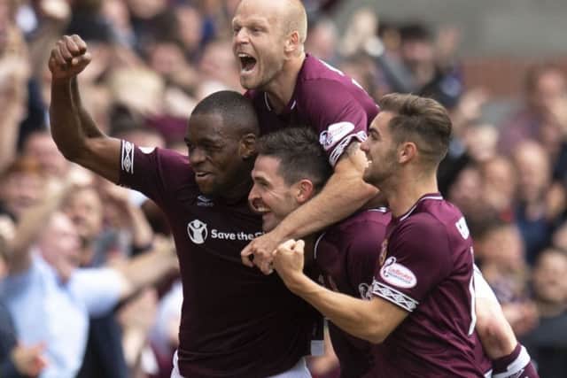 Kyle Lafferty is mobbed after scoring for Hearts against Celtic