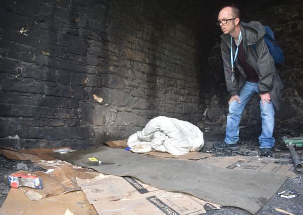 Nick Harrold from Cyrenians finds evidence that rough sleeping areas have not been used recently. Picture: Kieran Murray