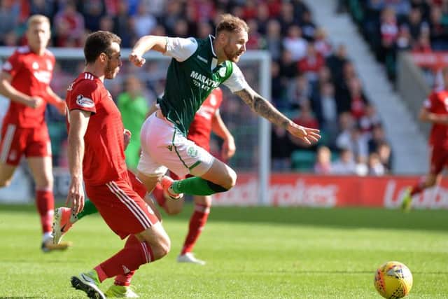 Martin Boyle is sent flying by Aberdeen defender Andrew Considine