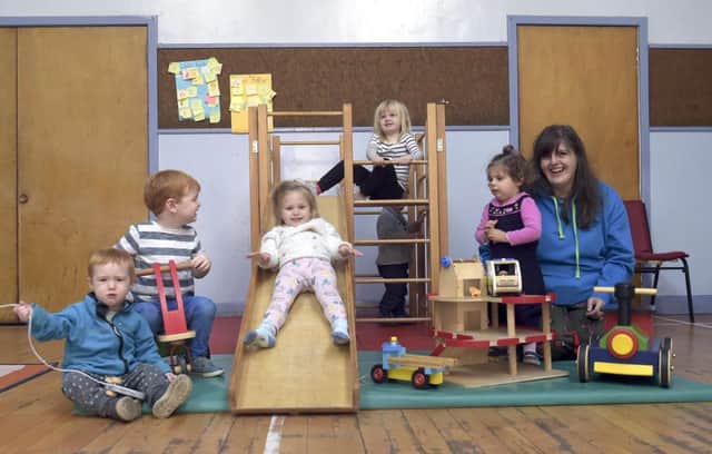 Ben Drake 18months, Alistair Drake 3, Alexis Holmes 2, Neive Porter 3, Regina Alomzi, Amira Alonzi-Sharshar


Regina Alonzi runs a baby and toddler group that uses only wooden toys in a bid to encourage sustainability and the development of children's imaginations.