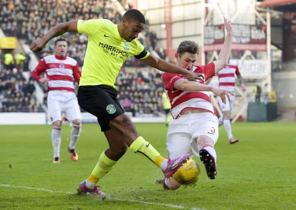Chris Humphrey of Hibs (left) is challenged by Ruaridh Donaldson at Tynecastle