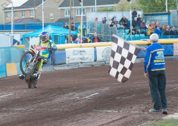 Monarchs No.1 Richie Worrall takes the chequred flag after being unbeaten all night. Pictures: Ron MacNeill