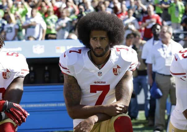 Former San Francisco 49ers' Quarterback Colin Kaepernick kneels during the national anthem before an NFL football game against the Seattle Seahawks. Kaepernick has a new deal with Nike, even though the NFL does not want him. Picture; AP