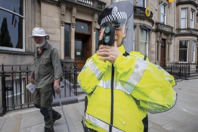 Bob the cardboard cut-out trains his speed gun on unwitting drivers. Picture: SWNS