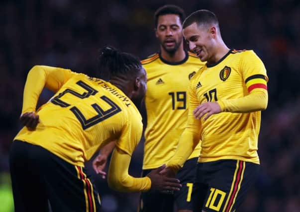 Michy Batshuayi celebrates with Belgium team-mates Eden Hazard and Mousa Dembele