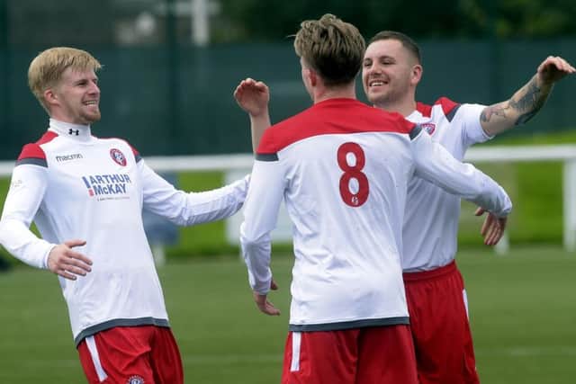 Spartans celebrate after Jamie Dishington (No.8) scores the only goal. Pic: Lisa Ferguson