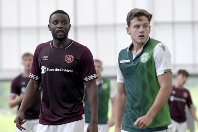 Clevid Dikamona (28) and Jamie Gullan (19) in action for Hearts and Hibs in the SPFL Reserve League Cup at Oriam. Picture: Lisa Ferguson