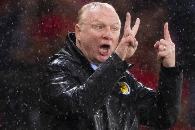 Scotland manager Alex McLeish barks orders amid a drenching