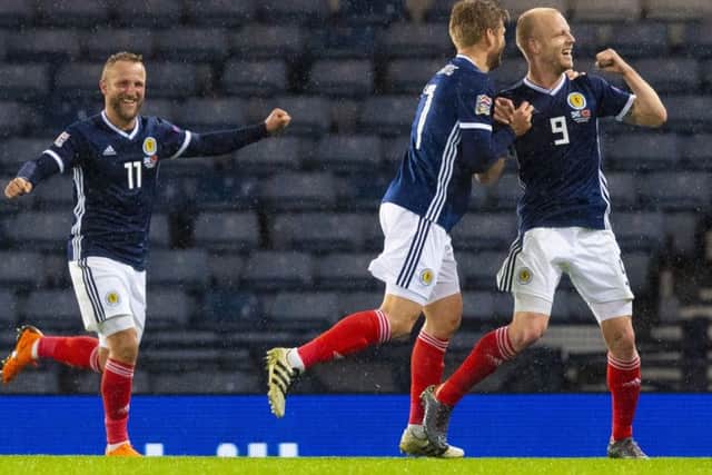 Scotland's Steven Naismith wheels away after he nods home the opener. Picture; SNS