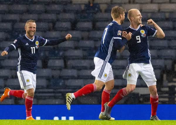 Scotland's Steven Naismith wheels away after he nods home the opener. Picture; SNS