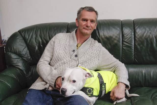 James Bjorkly and Eko, a Staffie assistance dog.
